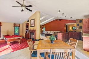 a living room with a table and a pool table at Great Group Getaway: Games Galore + Outdoor Oasis in Painesville