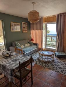 a living room with a couch and a table at Charmant appartement centre ville de Font-Romeu, vue montagne in Font Romeu Odeillo Via