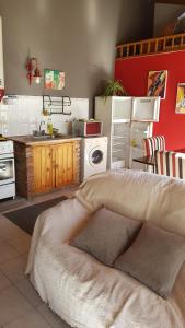 a kitchen with a bed and a kitchen with a sink at Casa con pileta "TU CASITA EN VIEDMA" calle Junin 1877 in Viedma