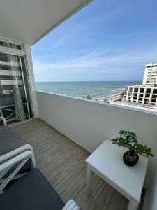 a balcony with a table and a view of the ocean at FRAGATA STYLE 2 in Cartagena de Indias
