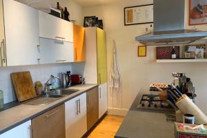 een keuken met een wastafel en een fornuis top oven bij Stylish & Homely 1BD Flat 1min to Clapton Sqaure! in Londen