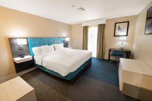 a hotel room with a large bed and a desk at Hampton Inn St Augustine US1 North in St. Augustine