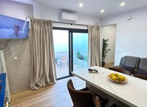 a living room with a table and a view of the ocean at Apartamento El Patio in Chipiona