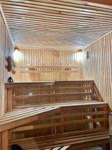 a sauna with wooden benches in a room at Садиба Карпат in Verkhovyna