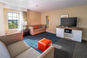 a living room with a couch and a flat screen tv at Hampton Inn St Augustine US1 North in Saint Augustine