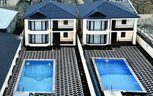 an aerial view of a house with two swimming pools at Qafqaz Manor Babylon in Gabala