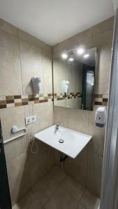 a bathroom with a sink and a mirror at Can Altavista in Puerto del Rosario