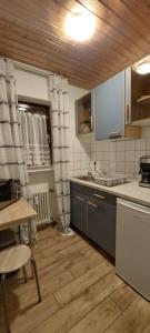 a kitchen with a table and a sink and a counter at FeWo1&Dreibettzimmer in Bad Wurzach