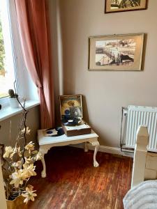 a room with a table with a picture on it at The Old House in Malbork