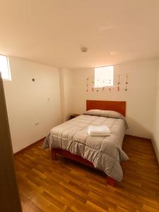 a bedroom with a bed in a room at Apartamento Mirador San Blas in Cusco