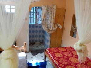a bedroom with a bed and a window with curtains at Sam & Miriam's Homestay in Nakuru