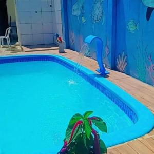 a swimming pool with a person doing a yoga pose at Pousada Encontro das Águas in Paripueira