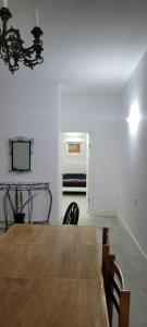 a dining room with a wooden table and chairs at Green door Valletta in Valletta