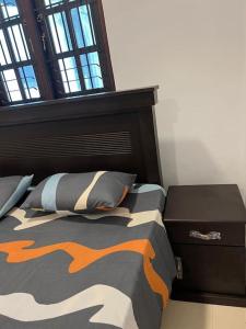 3 bedroom apartment in Colombo. في كولومبو: غرفة نوم مع سرير مع لحاف أسود وبرتقالي