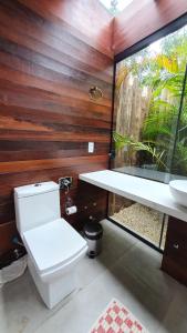 a bathroom with a toilet and a sink at Pousada Rosa Norte in Praia do Rosa