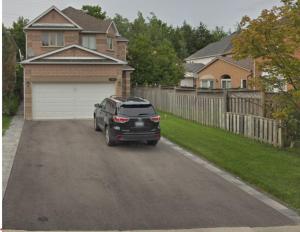 a black suv parked in front of a house at Large Separate Entrance Basement Unit 2Beds 1Washroom Sleeps 4-6 in Pickering