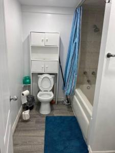 a small bathroom with a toilet and a shower at Large Separate Entrance Basement Unit 2Beds 1Washroom Sleeps 4-6 in Pickering