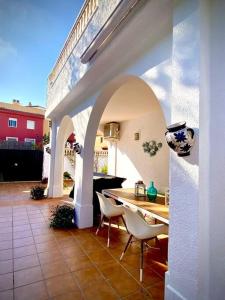 a patio with a table and chairs in a house at MyChoice Villa Almadraba in Rota