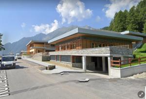 a building on the side of a road at Maison Chasseur Alpine Design Lodge in Champoluc