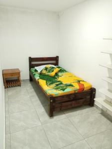 a bed sitting in a room with at Hostal Ninfa del Mar in Manizales