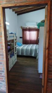 a small room with a bed and a bedroom with a bunk bed at Lugar de descanso ideal, Paraiso al lago, Ypacarai - Central in Ypacarai