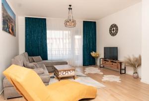 a living room with a couch and a tv at HH apartments in Bjelašnica