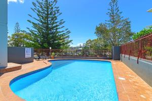 a swimming pool on a patio with trees in the background at Sundial 202 8-10 Hollingworth Street in Port Macquarie