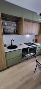 a kitchen with a sink and a stove at Urban Retreat Central - One bedroom apartment in Piteşti