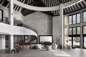 a living room with a spiral staircase and a piano at Villa Abrazos in San Pedro