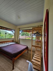 a bedroom with a bed and a wooden bunk ladder at PEDRA do CEPILHO in Trindade