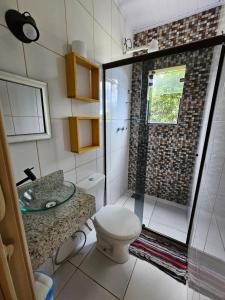 a bathroom with a shower with a toilet and a sink at PEDRA do CEPILHO in Trindade +42 photos