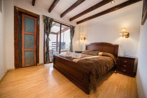 a bedroom with a large bed and a window at Hotel Casa del Barranco in Cuenca