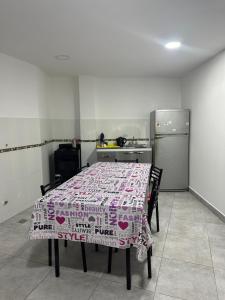 a kitchen with a table with a table cloth on it at Alojamiento amoblado in Perico