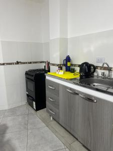 a kitchen with a sink and a stove at Alojamiento amoblado in Perico