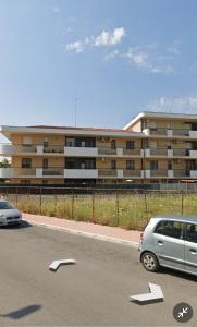 a van parked in a parking lot in front of a building at BRUMARI in Foggia