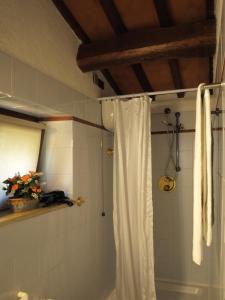 a bathroom with a shower with a white shower curtain at Agriturismo Podere 3 Querce in Manciano
