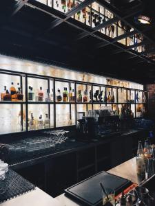 a bar with a lot of bottles on the wall at Hotel Flora in Schwäbisch Gmünd