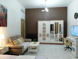 a living room with a couch and a table at Jumeirah Beach Villa in Dubai