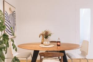 a dining room table with a candle and flowers on it at Beautiful 1BD Apartment Issy-les-Moulineaux! in Issy-les-Moulineaux