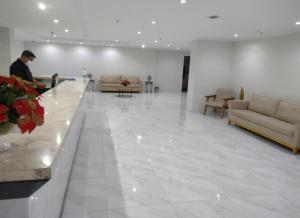 a man sitting on a couch in a lobby at Via Venetto FEIRINHA in Fortaleza +43 photos
