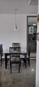 a dining room table with two chairs and a mirror at Via Venetto FEIRINHA in Fortaleza