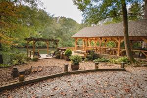 a gazebo with a picnic table and a pavilion at The Pines Riverside Log Cabin On The Ocoee in Ocoee