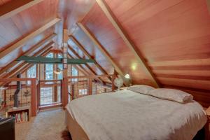 a bedroom with a bed in a wooden attic at Tahoma Retreat about 2 Mi to Homewood Mountain Resort in Tahoma
