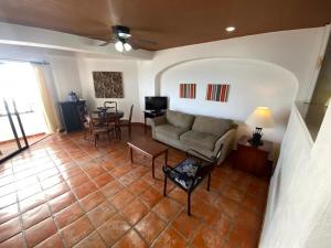 een woonkamer met een bank en een tafel bij one beach street hotel -Beach front Spacious 1BD 1BA fabulous view in Zona Romantic Puerto Vallarta in Puerto Vallarta