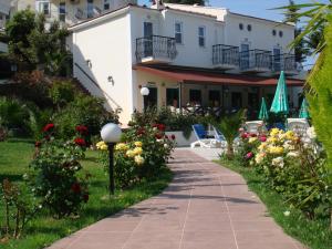 a walkway in front of a building with flowers at Ant Apart Hotel in Oludeniz