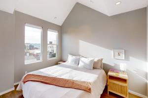 a bedroom with a large bed and a window at Luxury Ballard Townhome in Seattle