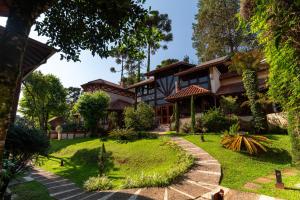 an exterior view of a house with a garden at Pousada Boutique Vilage de Minas in Monte Verde