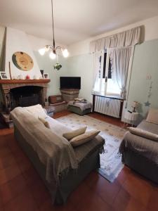 a living room with a bed and a fireplace at LA CASA DI GIM in Lugo