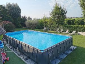 a large swimming pool in a yard with chairs at LA CASA DI GIM in Lugo