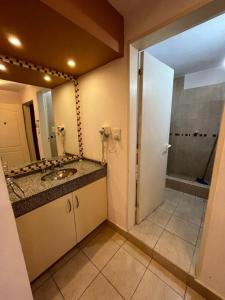 a bathroom with a sink and a shower at complejo miligamapa con piscina climatizada in Villa Carlos Paz